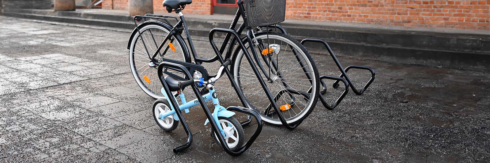 Close up of a bicycle rack, with a child's bike demonstrating its usage.